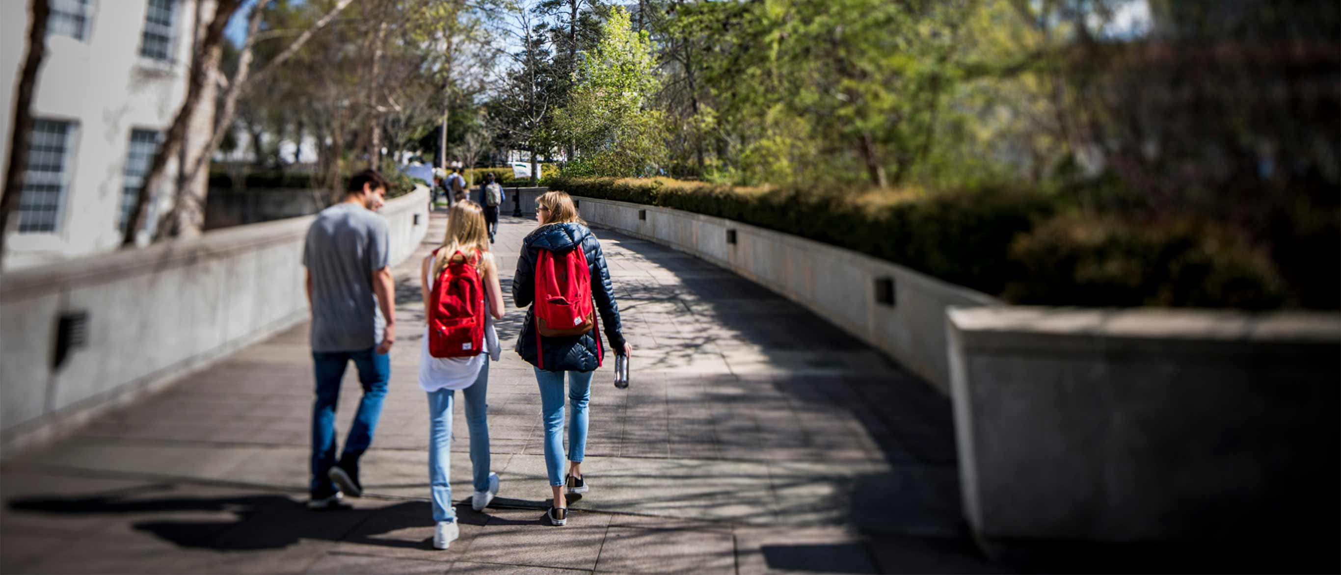 three students walking down a path on the Emory Atlanta campus