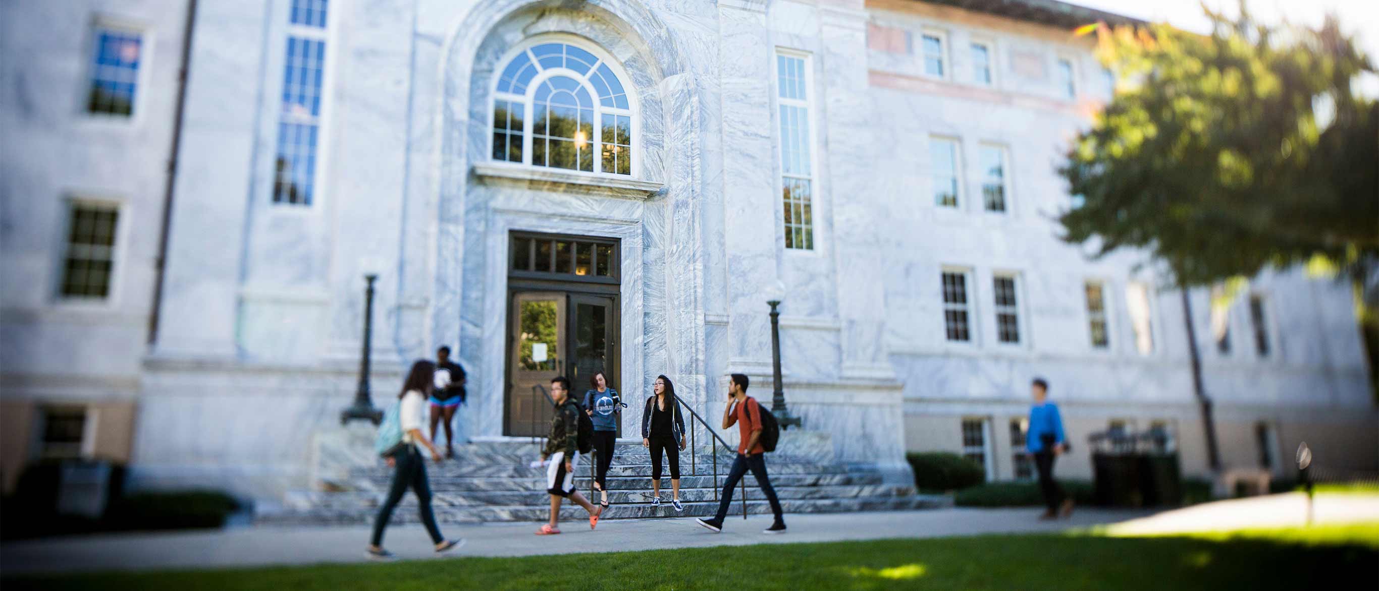 students walking in front of the Candler Library building