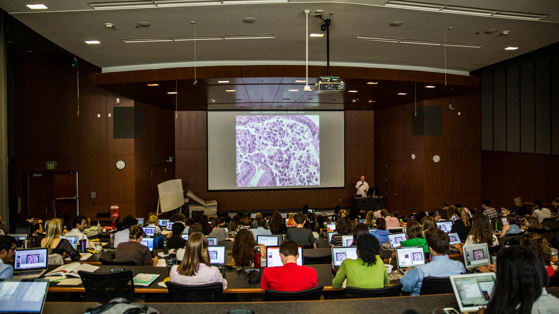 medical students viewing a projected slide in a large classroom