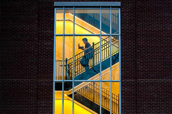 Silhouette of student walking down stairs in Math building