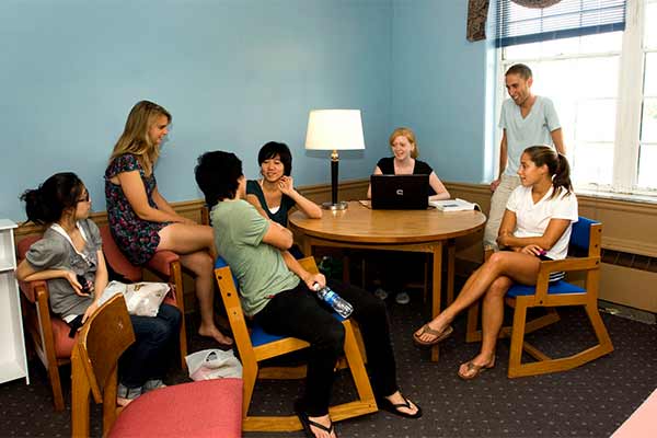 Students sitting around a table doing work